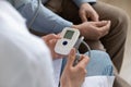 Close up of female nurse measure heartbeat of mature patient