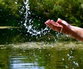 Close-up female palms toss water