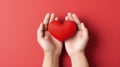 Close-up of female palms in which lies a red heart