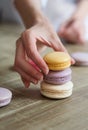 Close up of female pastry chef's hand cooking delicious macaroon