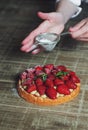 Close up of female pastry chef's hand decorating top of delicio Royalty Free Stock Photo