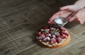 Close up of female pastry chef's hand decorating top of delicio Royalty Free Stock Photo