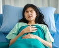 Close-up of female patient lying on hospital bed, covered with a soft blanket, sleeping tiredly after having medical treatment and Royalty Free Stock Photo