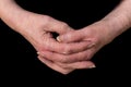 Close up of a female pensioner`s hands loosely clasped