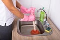 Close-up Of Woman Using Plunger In Sink Royalty Free Stock Photo