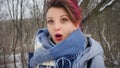 Close-up female portrait of glam rock style look of a beautiful girl with dark pink hair and mohawk wearing blue scarf Royalty Free Stock Photo