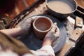 Close up of Female Potter Hands Working on Pottery Wheel at Clay Studio With Clay. Making Handcrafted Crockery Royalty Free Stock Photo