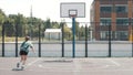 Close up of female professional basketball player making slam dunk during basketball game in floodlight basketball court