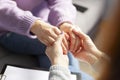 Close up of a female psychologist holding woman& x27;s hands during a therapy session.