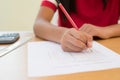 Close Up Of Female Pupil Taking Multiple Choice Examination Paper