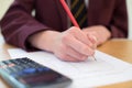 Close Up Of Female Pupil In Uniform Taking Multiple Choice Examination Paper