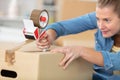 close-up female sealing cardboard box with adhesive tape Royalty Free Stock Photo