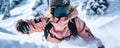 Close-up of female snowboarder wearing pink suit, black helmet and goggles in the mountains. Young blonde woman athlete Royalty Free Stock Photo