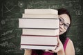Close-up female student bring stack of books in class Royalty Free Stock Photo