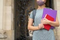 Close Up Of Female Student Standing Outside College Or University Building Wearing Face Mask During Covid-19 Pandemic