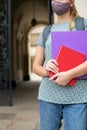 Close Up Of Female Student Standing Outside College Or University Building Wearing Face Mask During Covid-19 Pandemic