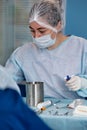 Close-up of a female surgeon in an operating room, a doctor with a tense expression on his face, in an operating room.