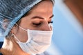 Close-up of a female surgeon in an operating room, a doctor with a tense expression on his face, in an operating room.