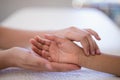 Close-up of female therapist examining wrist on white towel Royalty Free Stock Photo