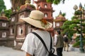 Close-up female tourist visiting Tran Quoc ancient pagoda, the oldest Buddhist temple in Hanoi, Vietnam Royalty Free Stock Photo