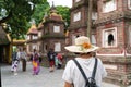 Close-up female tourist visiting Tran Quoc ancient pagoda, the oldest Buddhist temple in Hanoi, Vietnam Royalty Free Stock Photo