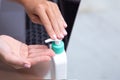 Close up of female worker sit in office clean hands use sanitizer against coronavirus pandemic, woman employee work on laptop Royalty Free Stock Photo