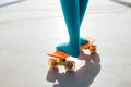 Close-up of female young girl legs in green socks standing on a orange plastic skateboard. Summer sports activities for teens, Royalty Free Stock Photo