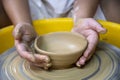 Close up of females ceramics maker working with pottery wheel
