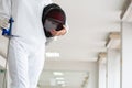 Close-up of a fencer in white fencing suit and holding her mask