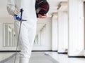 Close-up of a fencer in white fencing suit and holding mask and