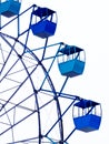 Close-up of the Ferris wheel, blue cabs against the sky, amusement Park Royalty Free Stock Photo