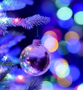 a close up of a christmas tree ornament with lights in the background Royalty Free Stock Photo