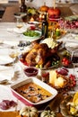 Close-up festive decorated table with roasted turkey and holiday traditional food, dishes. Happy Thanksgiving day Royalty Free Stock Photo