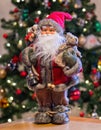 Close up of  a festive Father Christmas Doll with Christmas tree and lights Royalty Free Stock Photo