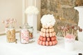 Close up of festive wedding tables with sweets, candies, dessert and fresh flowers