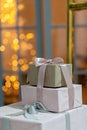 Close-up of festively wrapped gift boxes, on a Christmas background of sparkling lights, a magical New Year\'s background. Royalty Free Stock Photo