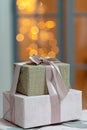 Closeup of festively wrapped gift boxes on a Christmas background of sparkling lights, a magical New Year\'s background. Royalty Free Stock Photo