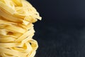 Close-up of fettuccine stack in horizontal on black background