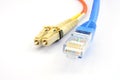Close up of a fiber optic patchcord head and UTP LAN cable head