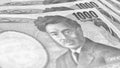 Close-up of a field of Japanese one thousand yen notes. Focus on number 1000. Bundle or surface of banknotes. Black and white