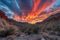 close-up of fiery canyon sunset, with clouds and mountains in the background