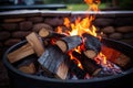 close-up of fiery wood logs in an open fire pit