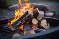 close-up of fiery wood logs in an open fire pit