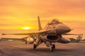 Close up fighter jet military aircraft parked on runway on sunset Royalty Free Stock Photo