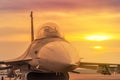 Close up fighter jet military aircraft parked on runway on sunset Royalty Free Stock Photo