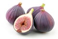 Close-up of figs on wooden table. Fresh slice of fig lying on a heap of ripe figs. Heap of tasty organic figs. Ripe exotic fruit. Royalty Free Stock Photo