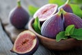 Close-up of figs on wooden table. Fresh slice of fig lying on a heap of ripe figs. Heap of tasty organic figs. Ripe exotic fruit. Royalty Free Stock Photo