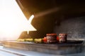 Close-up of filet mignon vegetables and meat on a bbq grill on a skyscraper rooftop at sunset. Fire in the barbecue