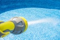 Close-up of filling the water into an empty swimming pool by garden hose Royalty Free Stock Photo