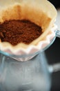 Close up filter coffee bunch brewing origami dripper. Freshly ground coffee. Specialty concept. Alternative brew Royalty Free Stock Photo